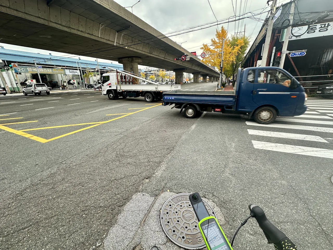 Truck traffic under an elevated road in Busan